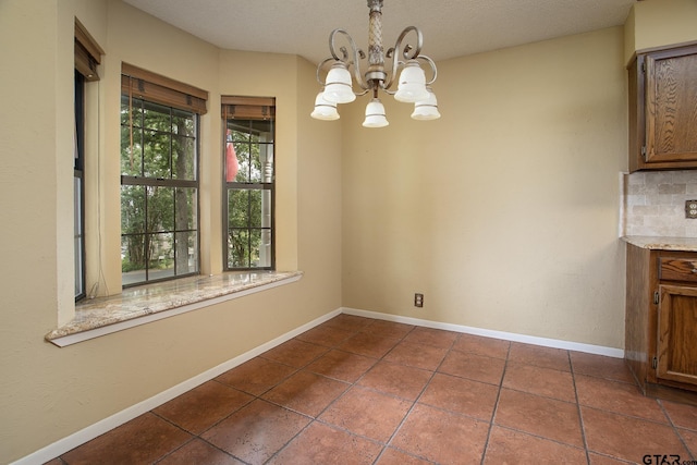 17617 Carol Cir, Flint, TX 75762 - unfurnished dining area featuring a chandelier, dark tile patterned flooring, and baseboards