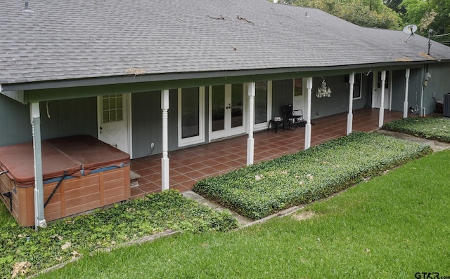 17617 Carol Cir, Flint, TX 75762 - back of property with a hot tub, a shingled roof, french doors, a patio area, and central AC