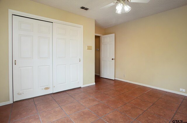 17617 Carol Cir, Flint, TX 75762 - unfurnished bedroom with baseboards, a closet, tile patterned floors, a textured ceiling, and ceiling fan