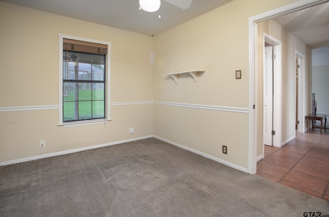 17617 Carol Cir, Flint, TX 75762 - carpeted empty room with a textured ceiling, ceiling fan, baseboards, and tile patterned flooring