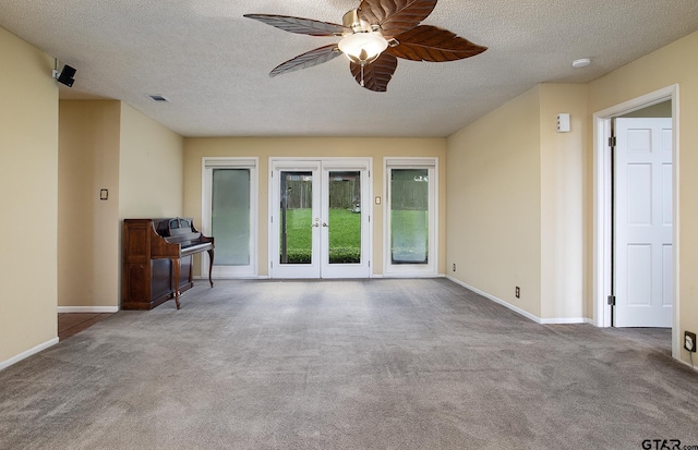 17617 Carol Cir, Flint, TX 75762 - carpeted living area featuring ceiling fan, a textured ceiling, baseboards, and french doors
