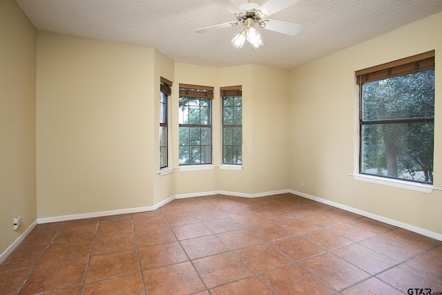17617 Carol Cir, Flint, TX 75762 - tiled spare room featuring plenty of natural light, a textured ceiling, ceiling fan, and baseboards
