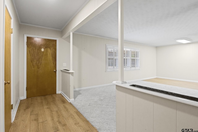 hallway featuring light hardwood / wood-style flooring and ornamental molding