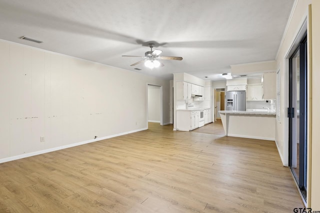 unfurnished living room featuring light hardwood / wood-style flooring and ceiling fan