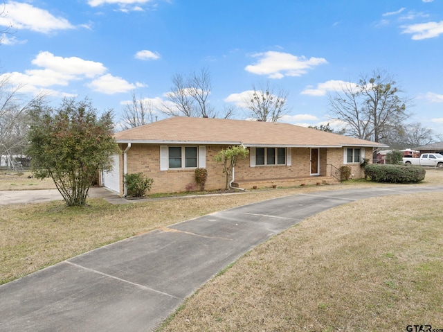 ranch-style home with a garage and a front yard