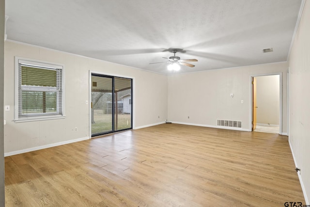 spare room with ceiling fan, crown molding, a textured ceiling, and light wood-type flooring