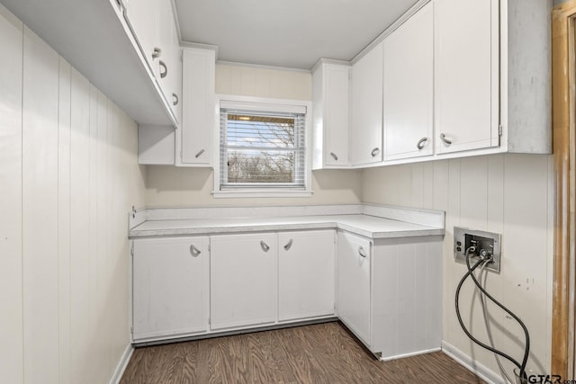 clothes washing area with cabinets, dark wood-type flooring, and washer hookup