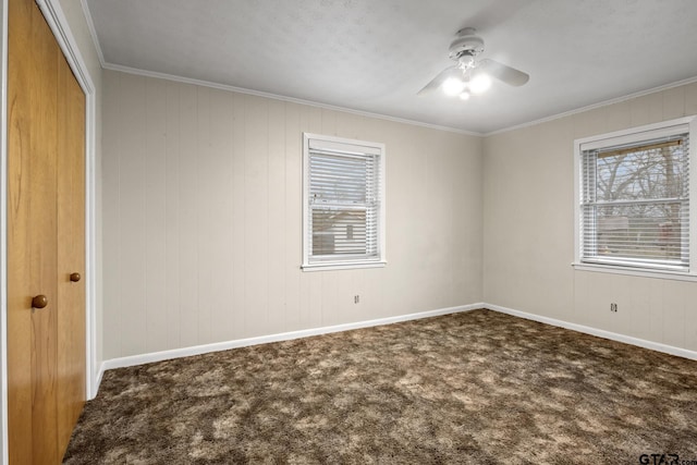 spare room featuring carpet floors, ornamental molding, and ceiling fan