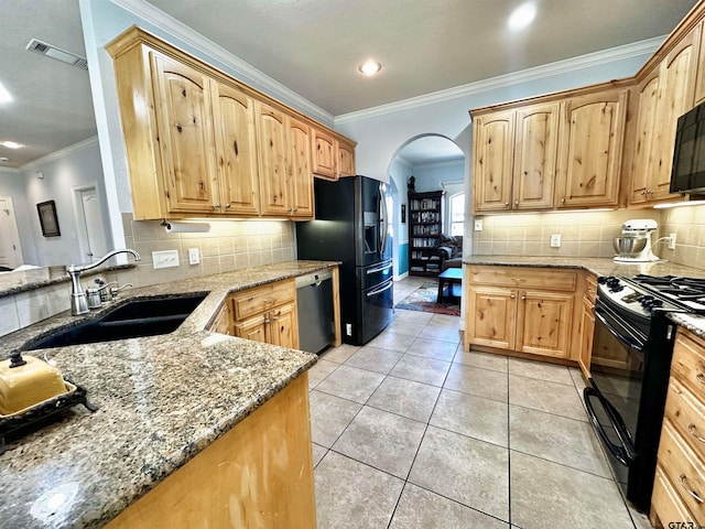 kitchen featuring light stone counters, crown molding, black appliances, sink, and light tile patterned flooring