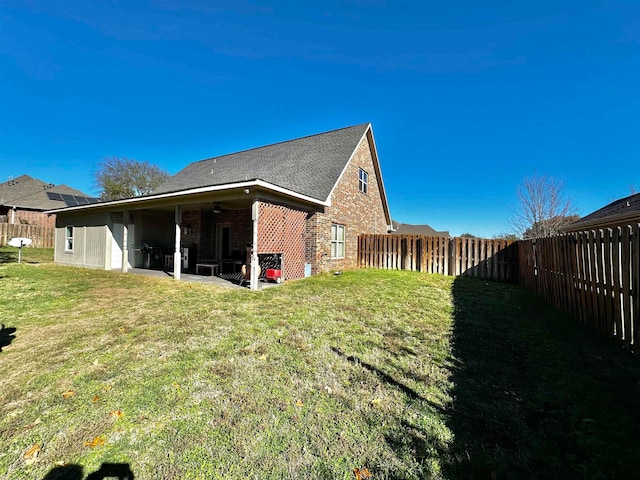 view of property exterior with ceiling fan, a yard, and a patio