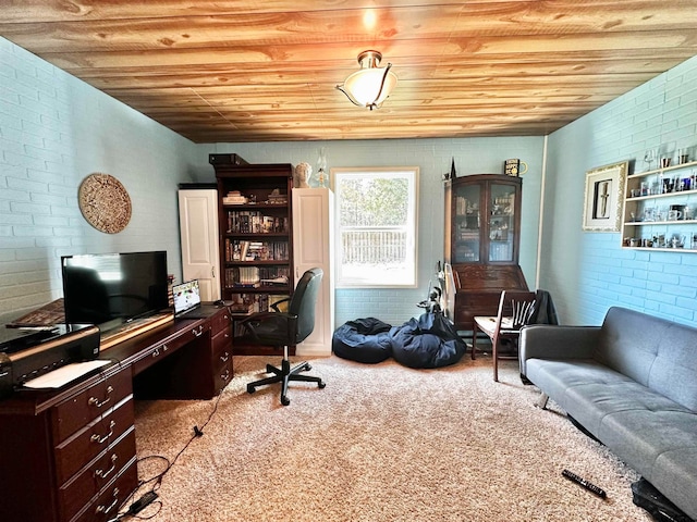 office featuring brick wall, light colored carpet, and wood ceiling