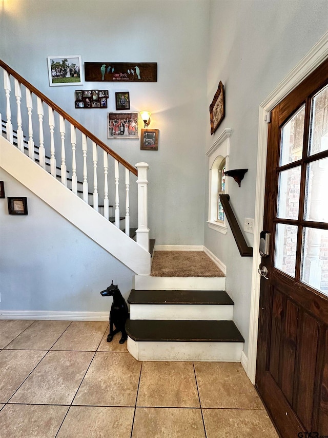 tiled entrance foyer with a healthy amount of sunlight