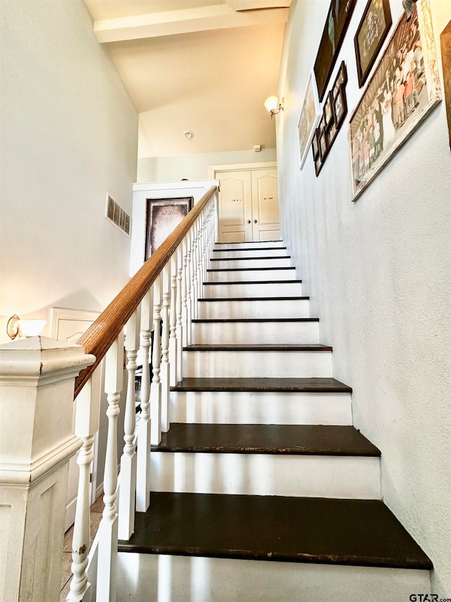 stairs with vaulted ceiling