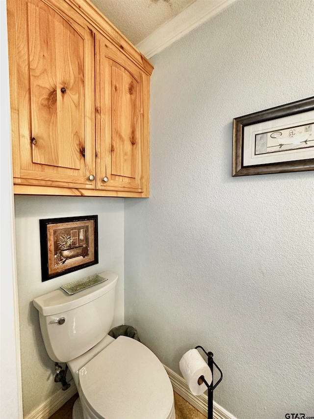 bathroom with a textured ceiling and toilet