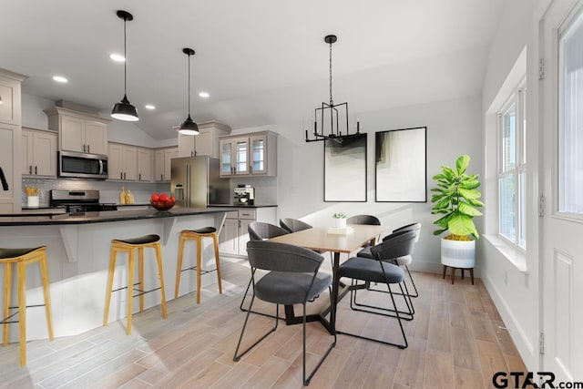 16234 Crossing Cir, Lindale, TX 75771 - dining space featuring recessed lighting, a chandelier, lofted ceiling, light wood finished floors, and baseboards