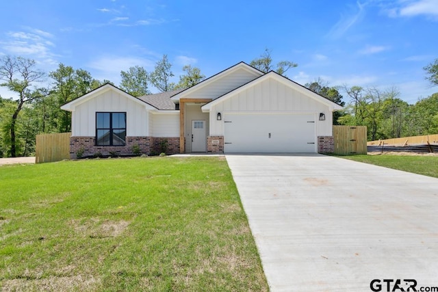 16234 Crossing Cir, Lindale, TX 75771 - modern farmhouse with driveway, board and batten siding, brick siding, a garage, and fence