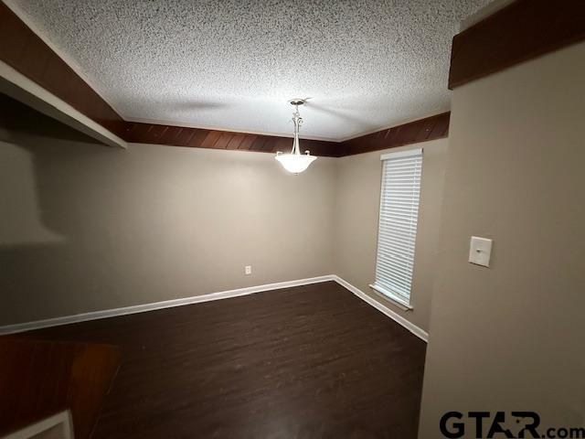 2523 Westminster Dr, Tyler, TX 75701 - empty room with a textured ceiling and dark wood finished floors