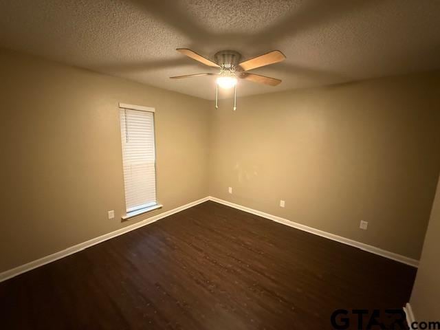 2523 Westminster Dr, Tyler, TX 75701 - unfurnished room with dark wood-type flooring, ceiling fan, and a textured ceiling