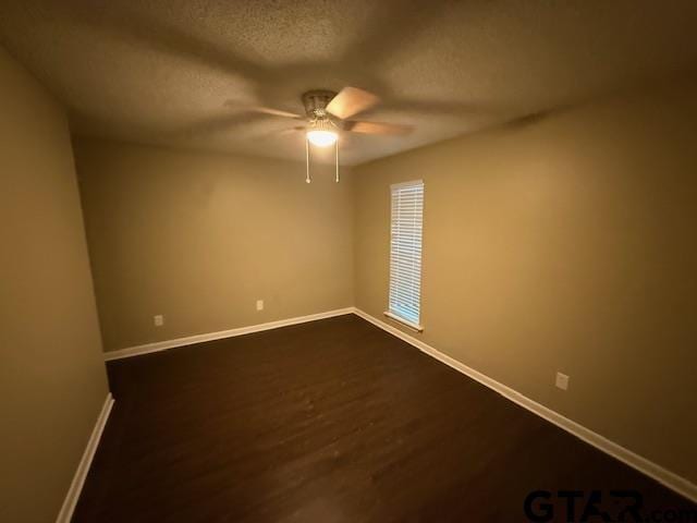 2523 Westminster Dr, Tyler, TX 75701 - spare room featuring a ceiling fan, a textured ceiling, and dark wood-style flooring