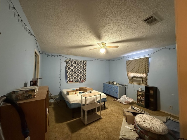 carpeted bedroom with ceiling fan and a textured ceiling