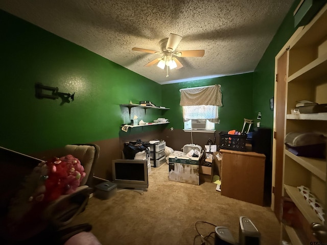 misc room with ceiling fan, a textured ceiling, carpet, and cooling unit