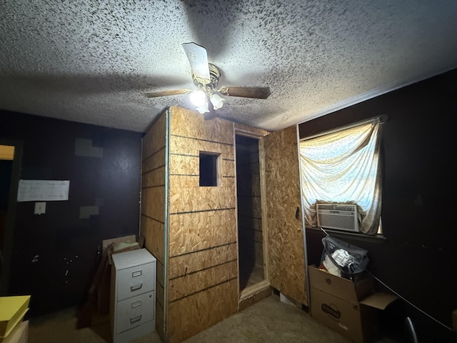 bedroom featuring ceiling fan, cooling unit, light carpet, and a textured ceiling