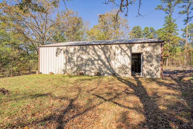 view of outdoor structure with a lawn