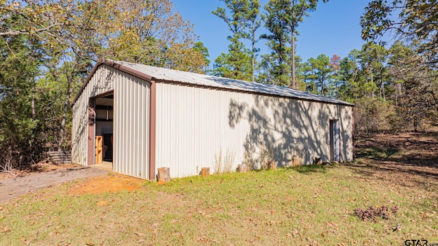 view of outbuilding featuring a lawn