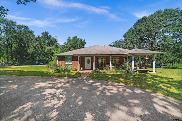 ranch-style home with a front yard and a porch