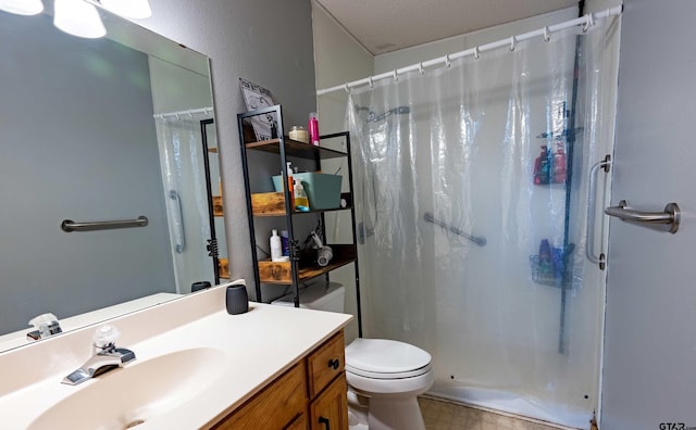 bathroom featuring a stall shower, vanity, toilet, and tile patterned floors