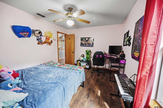 bedroom with visible vents, ceiling fan, a textured ceiling, and wood finished floors