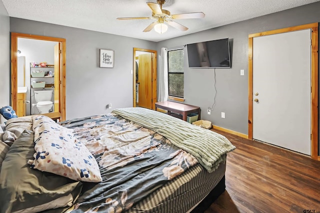 bedroom with baseboards, ceiling fan, wood finished floors, ensuite bathroom, and a textured ceiling