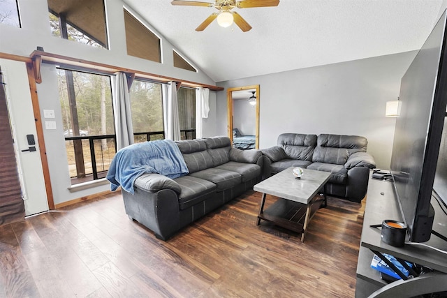 living area featuring a ceiling fan, plenty of natural light, a textured ceiling, and wood finished floors