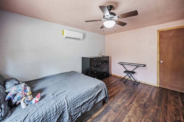 bedroom featuring a wall mounted air conditioner, ceiling fan, baseboards, and wood finished floors