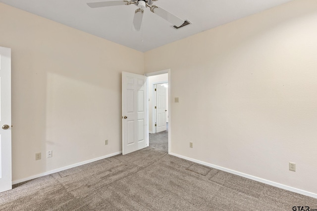 spare room with ceiling fan and carpet flooring