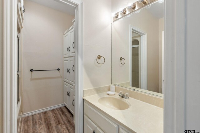 8099 W Interstate Highway 30, Cumby, TX 75433 - bathroom featuring wood finished floors, vanity, and baseboards