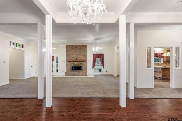 8099 W Interstate Highway 30, Cumby, TX 75433 - unfurnished living room featuring crown molding, a fireplace, carpet, ceiling fan, and a chandelier