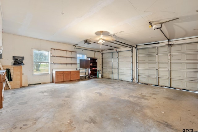 garage with a garage door opener and ceiling fan