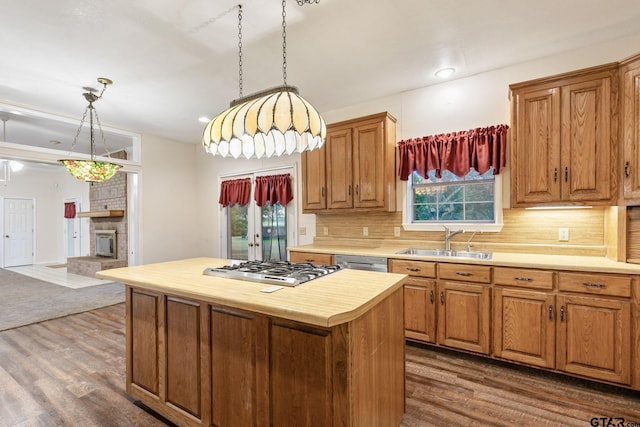 kitchen featuring dark wood-type flooring, sink, backsplash, and a kitchen island