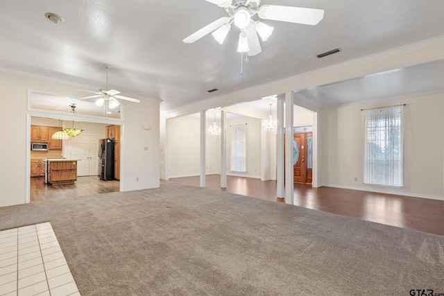 unfurnished living room with light wood-type flooring, ceiling fan with notable chandelier, and crown molding