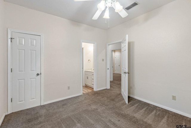 unfurnished bedroom with light carpet, ceiling fan, and connected bathroom