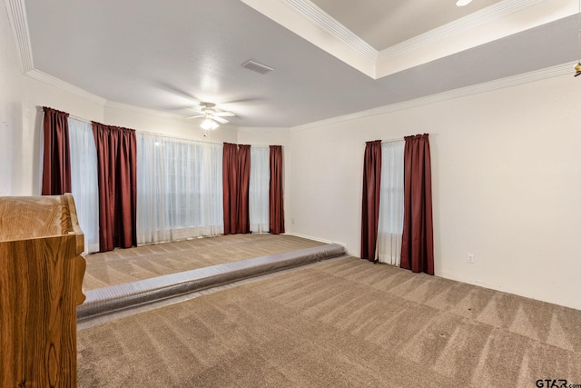 unfurnished bedroom featuring carpet, ceiling fan, and crown molding