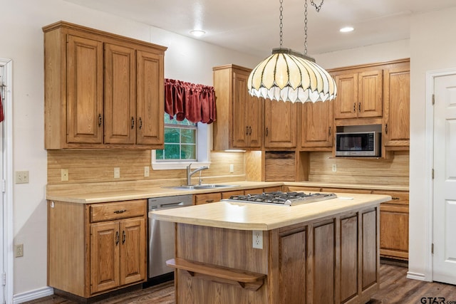 kitchen with stainless steel appliances, dark hardwood / wood-style floors, decorative light fixtures, a kitchen island, and decorative backsplash