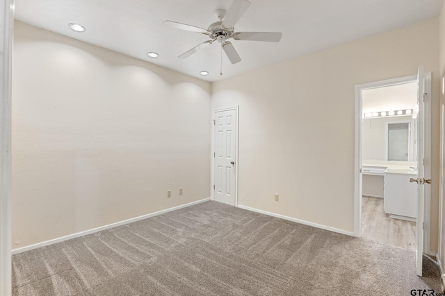 unfurnished room featuring ceiling fan and light colored carpet