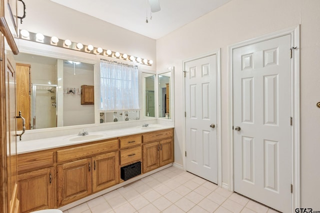 bathroom featuring tile patterned flooring, vanity, ceiling fan, and a shower with door