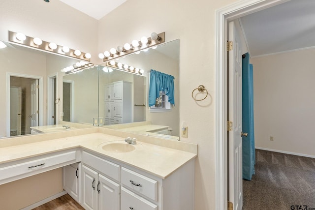 bathroom with ornamental molding and vanity