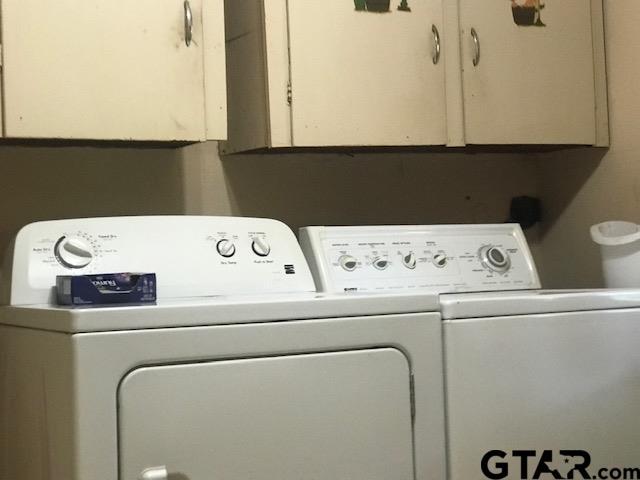 laundry area featuring cabinets and separate washer and dryer