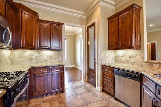 kitchen with light stone countertops, ceiling fan, stainless steel appliances, kitchen peninsula, and a breakfast bar