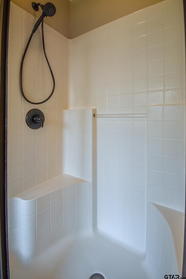 bathroom with a tile shower