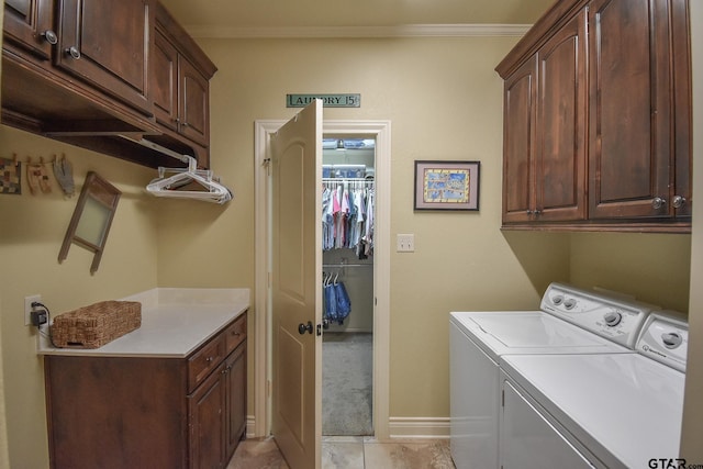 laundry area featuring washer and dryer, cabinets, ornamental molding, and light tile patterned floors